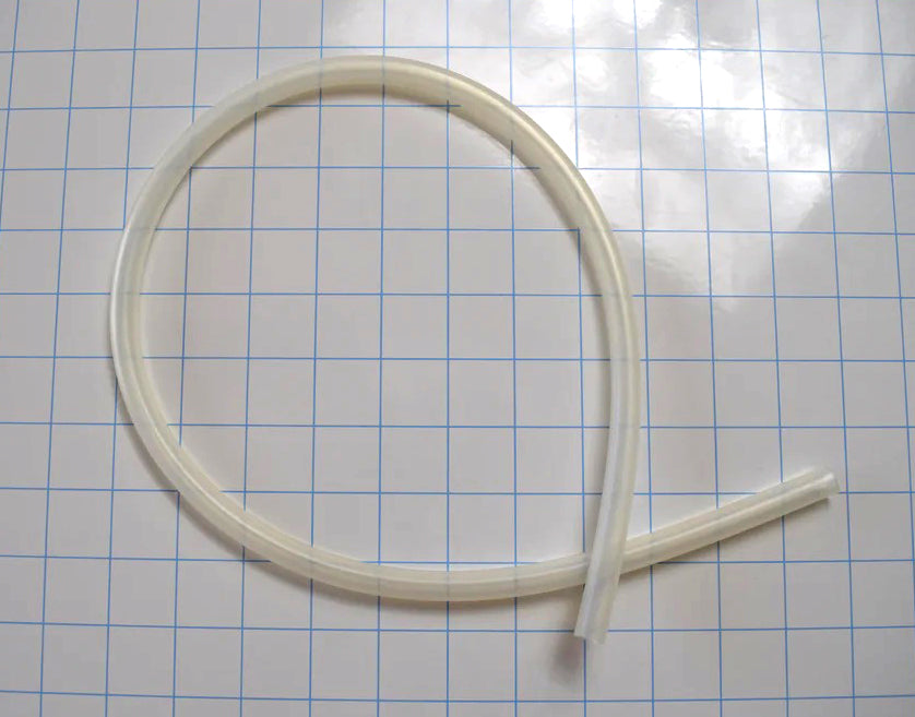 Flexible translucent 1/4 inch inner diameter silicone tubing coiled on a grid paper background.