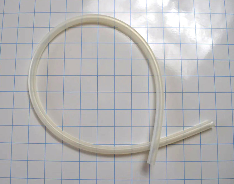 Flexible translucent 1/4 inch inner diameter silicone tubing coiled on a grid paper background.