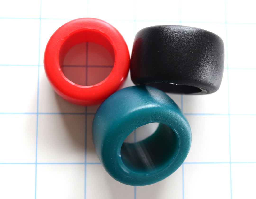 Erection Stamina Ring 1-inch inside diameter silicone sensory ring, 1-inch wide, available in multiple softness levels and colors on a blue grid background.