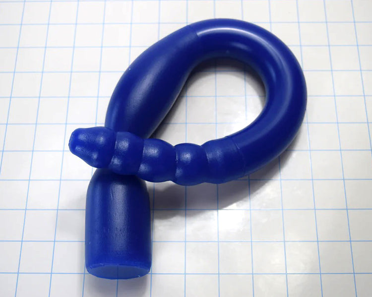 1.35-inch diameter, 18-inch blue silicone colon tube with Tip A design and 1.75-inch flange, shown on a grid background. piece coiled