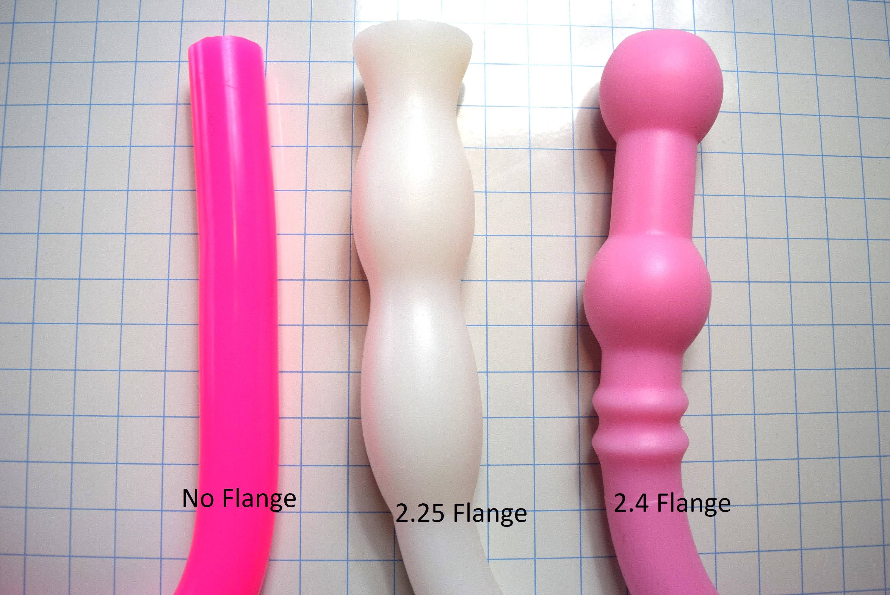 Comparison of 1.6-inch diameter silicone colon tube flange options, including no flange, 2.25-inch flange, and 2.4-inch flange designs on a grid background
