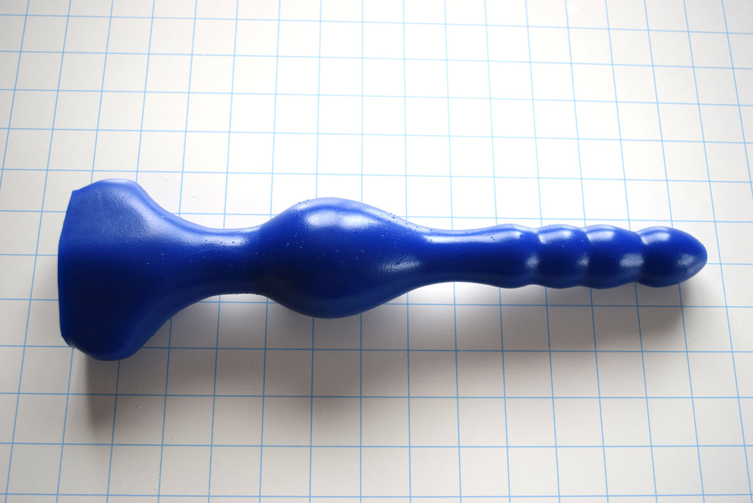 13.5-inch oval flange silicone enema nozzle featuring a large retention swell and contoured base for gluteal comfort
