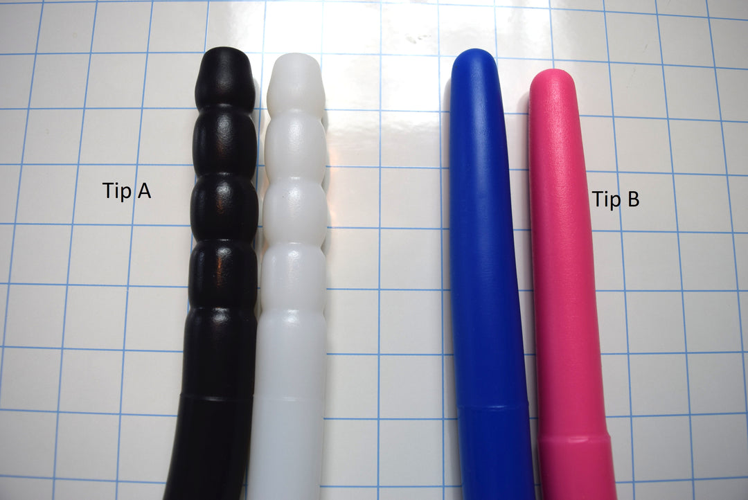 Comparison of Tip A and Tip B silicone colon tube designs, showing black, white, blue, and pink color options on a grid background