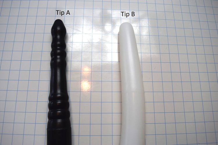 Comparison of Tip A and Tip B 2-inch silicone colon tube designs, showing black tip a, translucent white tip b on a grid background