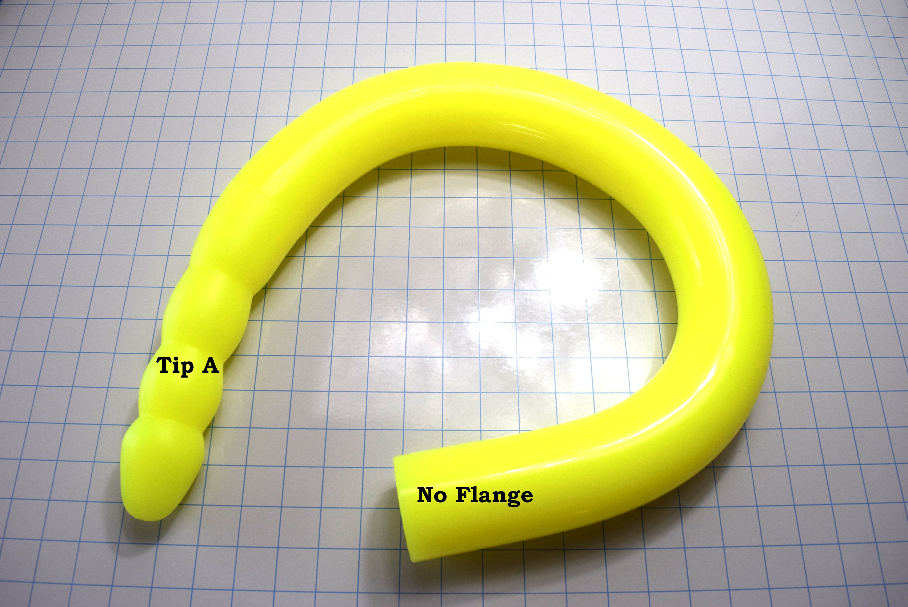 2.5-inch diameter, fluorescent yellow silicone colon tube with Tip a design and no flange, shown on a grid background.
