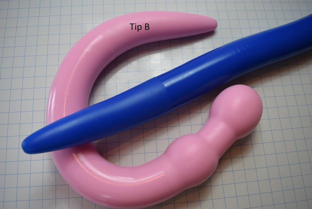 3-inch diameter, pink silicone colon tube with 3.5-inch flange, shown on a grid background, along with blue silicone colon tube with no flange