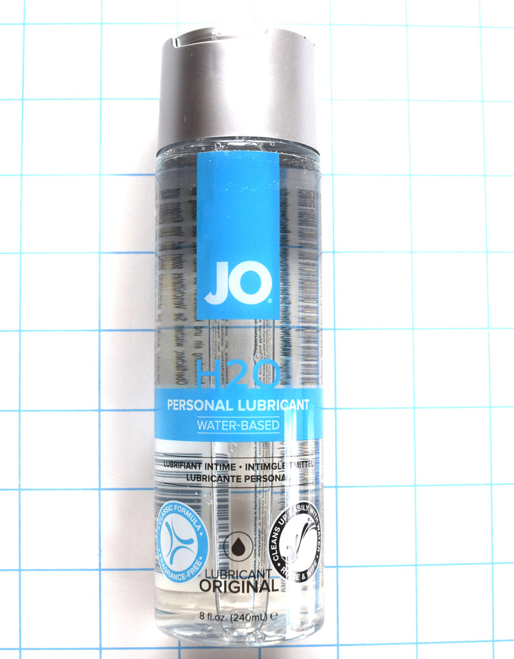 Upright bottle of 8oz JO H2O water-based personal lubricant on a blue grid background.