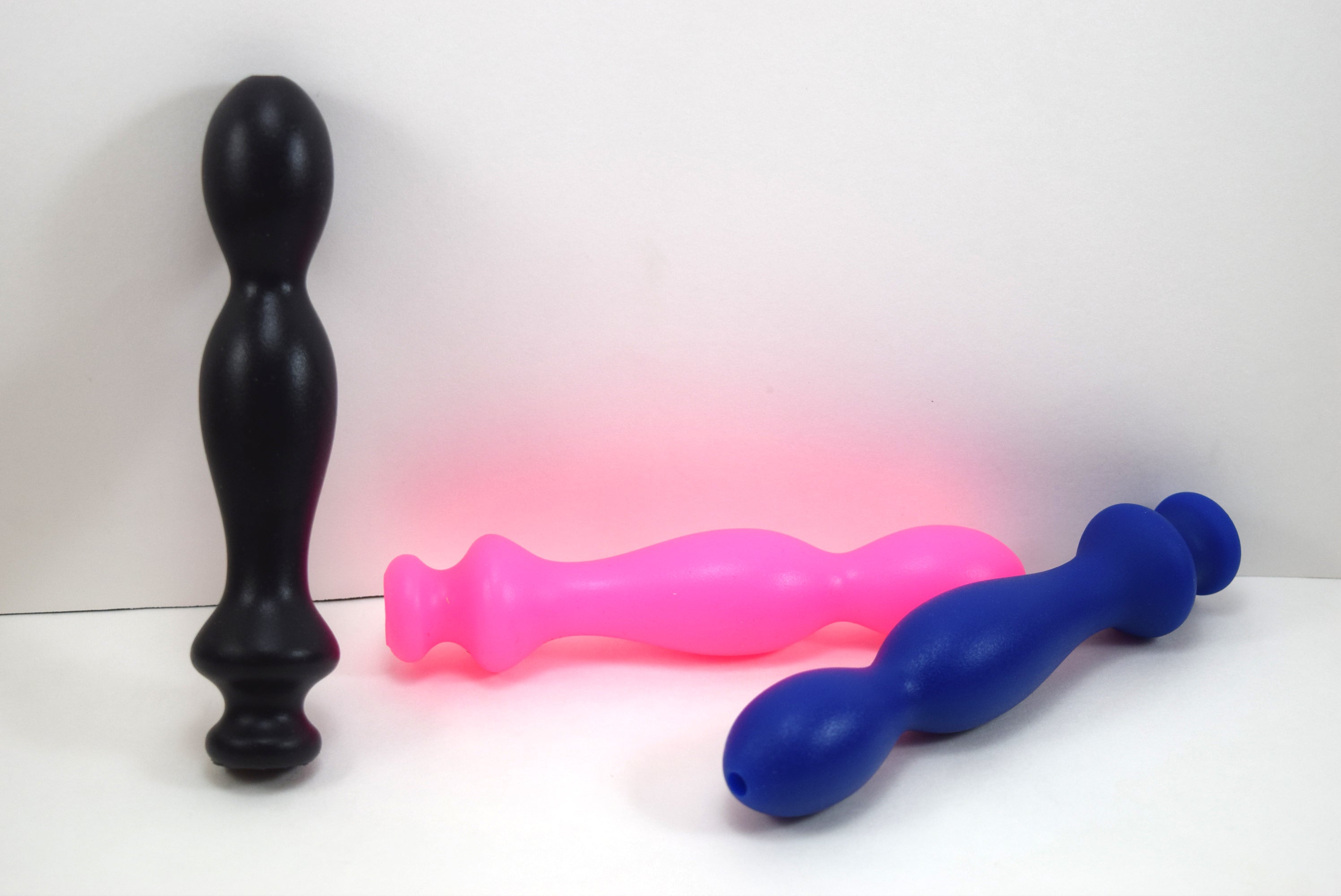 Group shot of Small Ball Tip silicone nozzles in blue, black, and fluorescent pink color variations on a white background