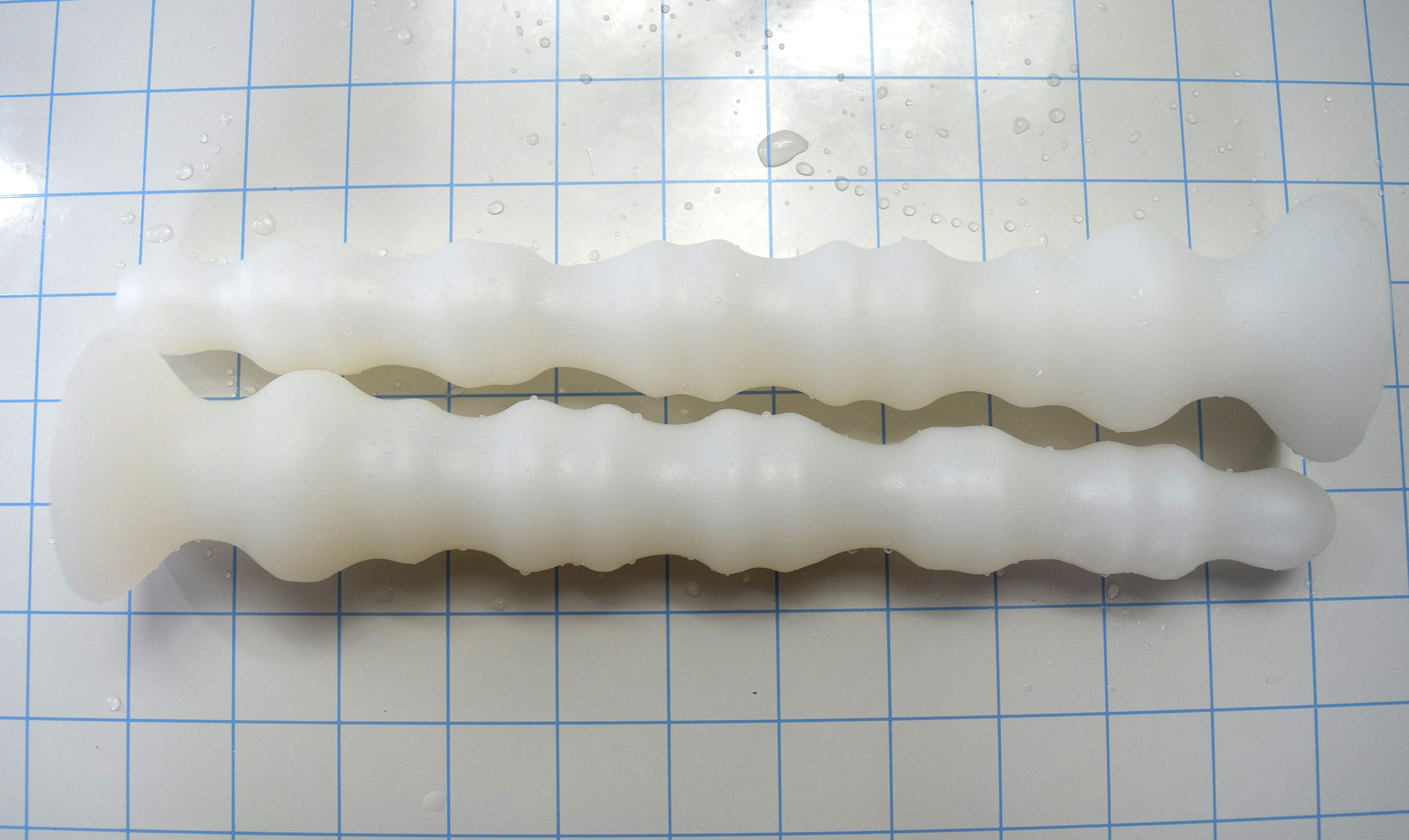 Multi-dimensional enhanced rib silicone enema nozzle with graduated ribbed texture and flared safety base, 10.5 inches long