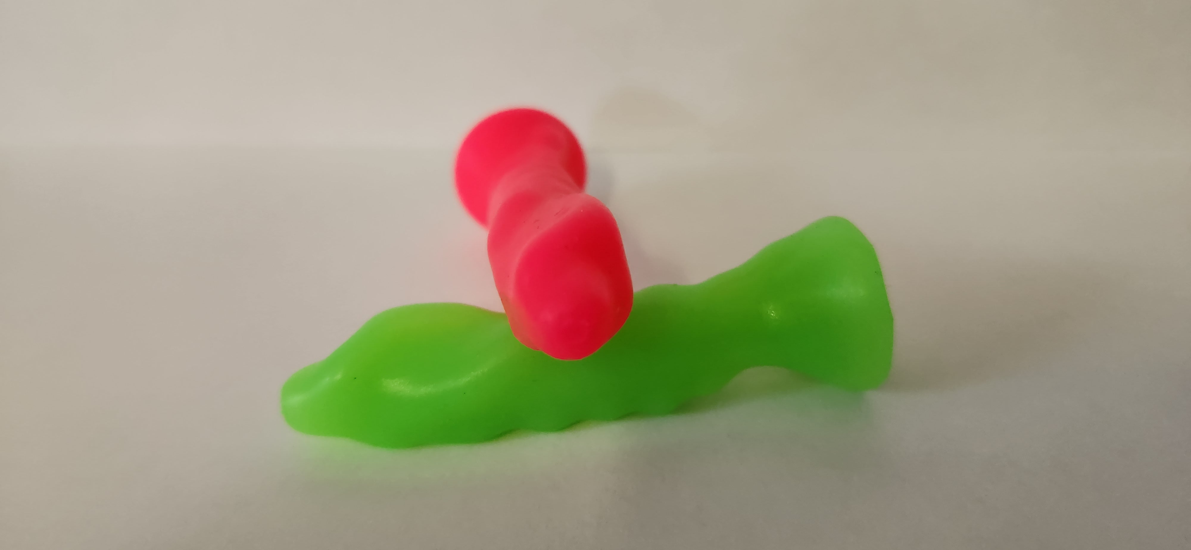 SSND Thing showing raised bumps and nodules texture detail, one pink, one green