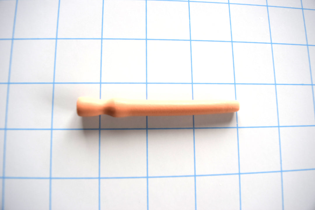 A small beginner-friendly silicone catheter displayed on a blue grid background.