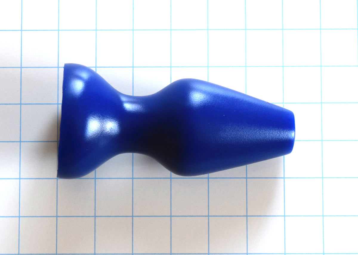 CSRE 2.5-inch rounded-edge colonic speculum retention enhancer in royal blue silicone on a blue grid background, showcasing its 6-inch total length, 4.75-inch insertable depth, and wide 3-inch flanged base