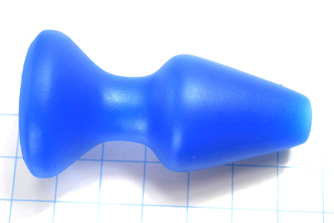 CSRE 2.5-inch rounded-edge colonic speculum retention enhancer in royal blue silicone on a blue grid background, showcasing its 6-inch total length, 4.75-inch insertable depth, and wide 3-inch flanged base