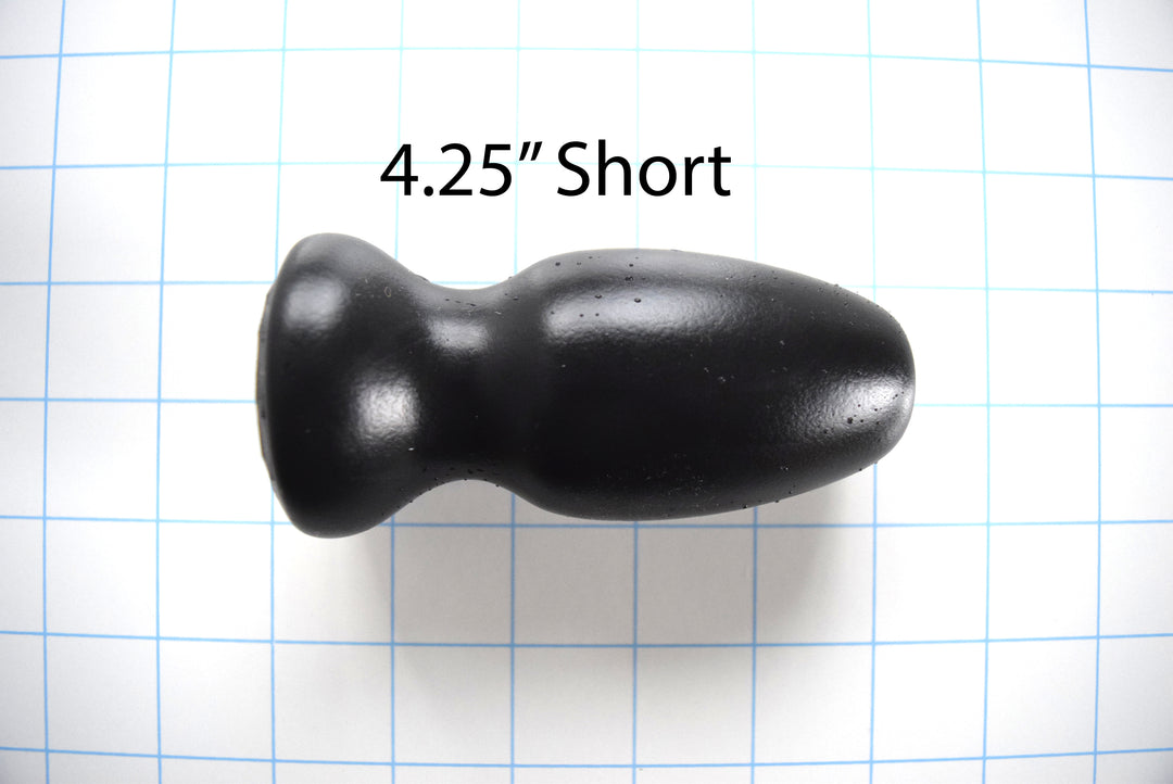 Black silicone CSRE colonic speculum retention enhancer, 4.25-inch short version, displayed on a blue grid background with a 4.25-inch short text measurement overlay.