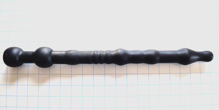 DMD 1.8 18.5-inch black silicone nozzle featuring a multi-ribbed shaft, 1.8-inch retention ball, and flared safety base on a white grid background