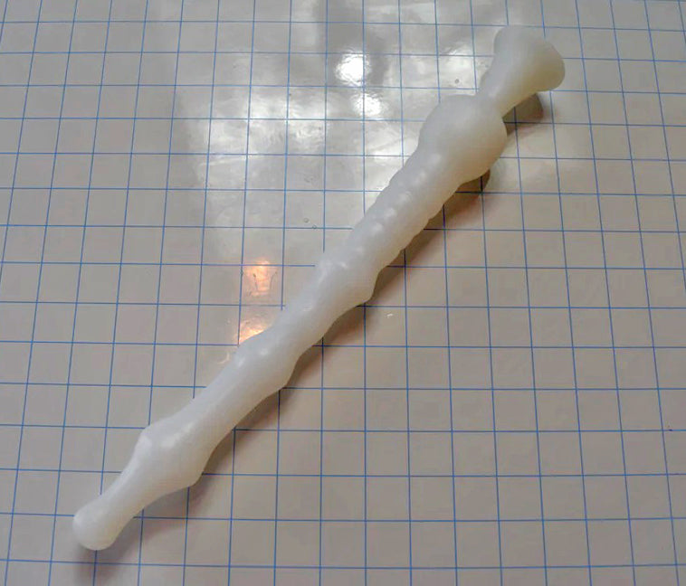 DMD 16-inch white silicone nozzle with multiple ribs, sensory valleys, and a 2-inch retention ball for sigmoid colon delivery on a white grid background