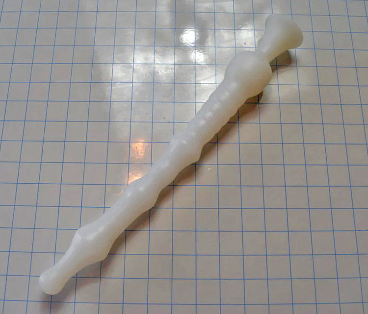 DMD 16-inch white silicone nozzle with multiple ribs, sensory valleys, and a 2-inch retention ball for sigmoid colon delivery on a white grid background