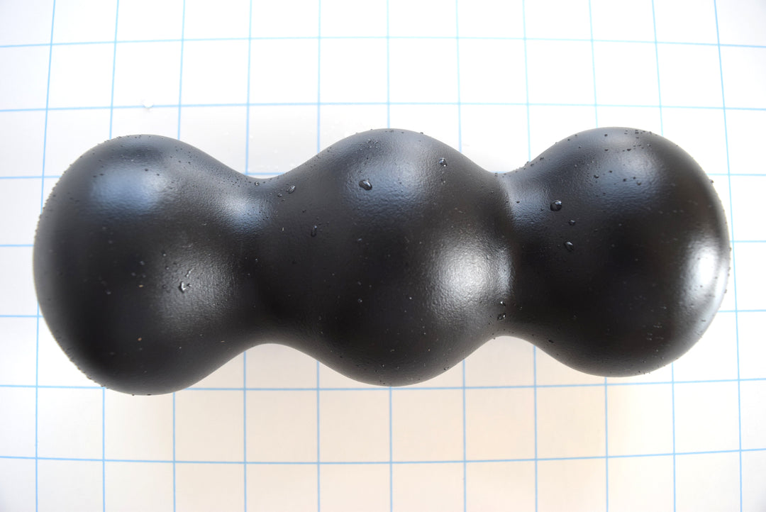 ED-ESS 4 7.5-inch oversized triple ball enhancement sleeve with a 2.85-inch ball diameter, 1.85-inch valley areas, and customizable inner core options on a grid background.