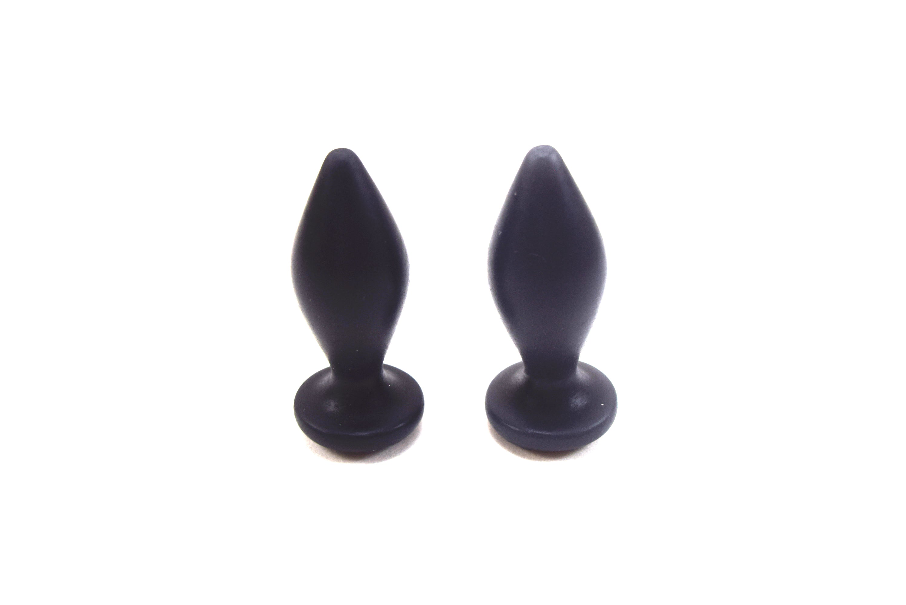 Pair of Expanded Diamond 1-inch black silicone retention nozzles showcasing their wide faceted diamond bodies, 2-inch insertable lengths, ultra-slim retention valleys, and flat safety flanges on a grid background.