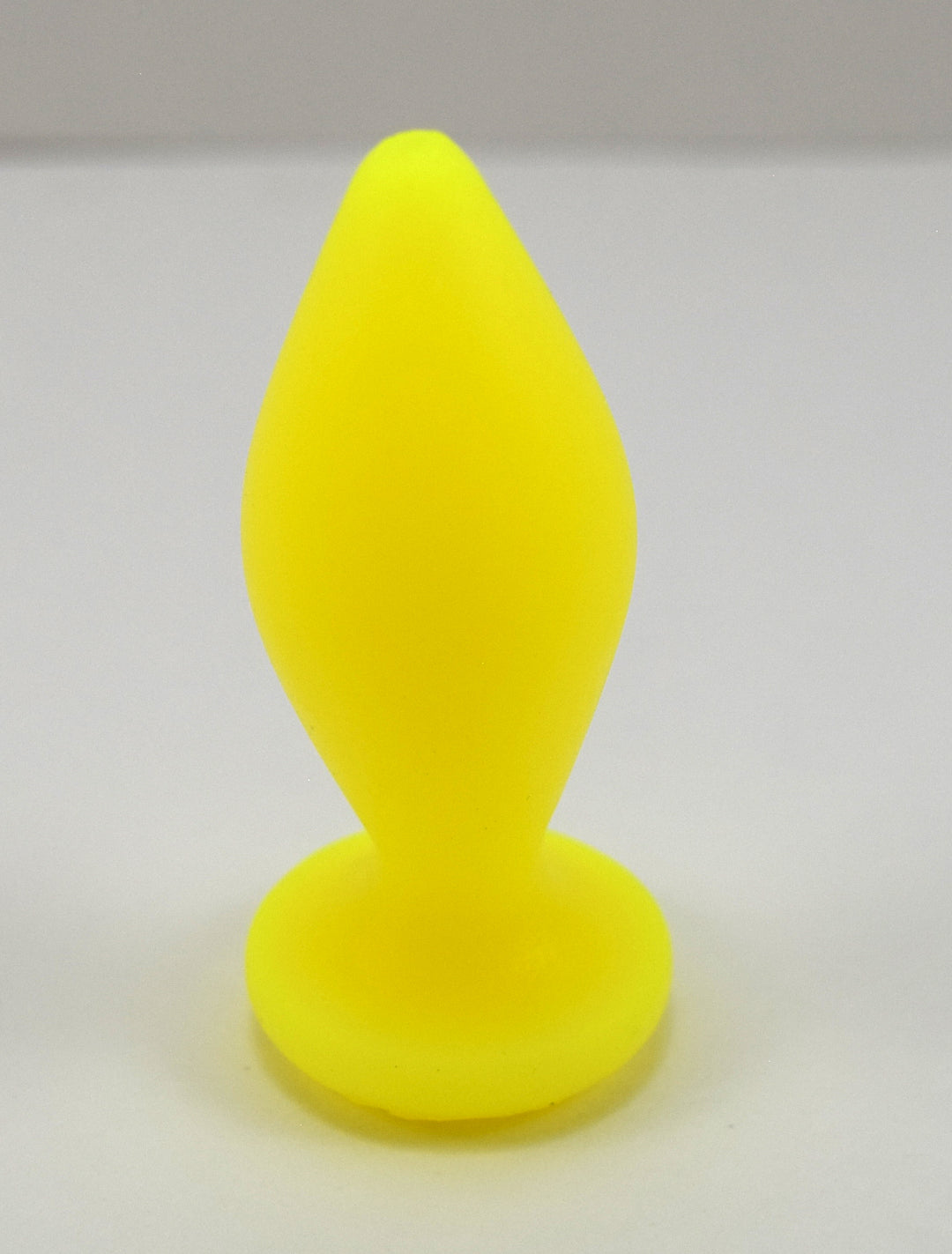 Expanded Diamond 1-inch fluorescent yellow silicone retention nozzle featuring a wide faceted diamond body, 2-inch insertable length, ultra-slim retention valley, and flat safety flange on a grid background.