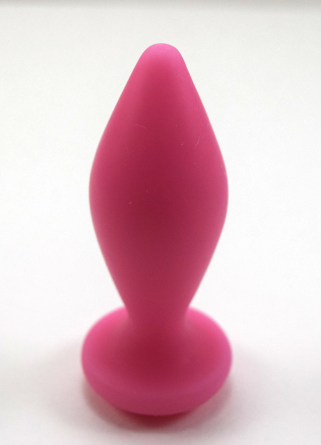 Expanded Diamond 1-inch pink silicone retention nozzle featuring a wide faceted diamond body, 2-inch insertable length, ultra-slim retention valley, and flat safety flange on a grid background.