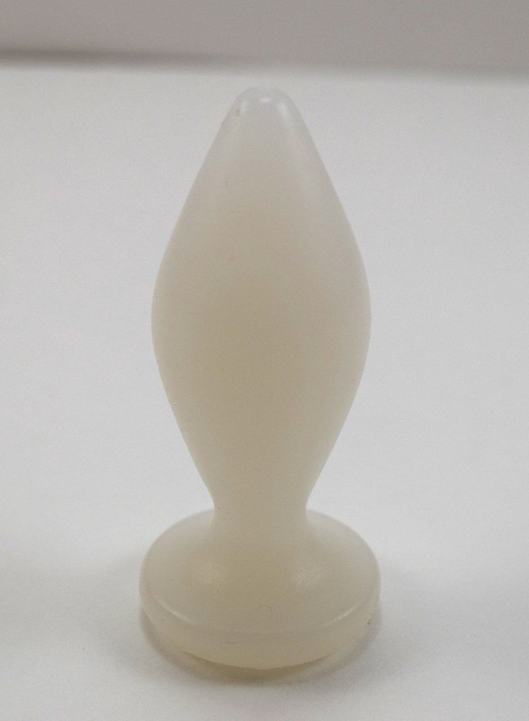 Expanded Diamond 1-inch translucent white silicone retention nozzle featuring a wide faceted diamond body, 2-inch insertable length, ultra-slim retention valley, and flat safety flange on a grid background.