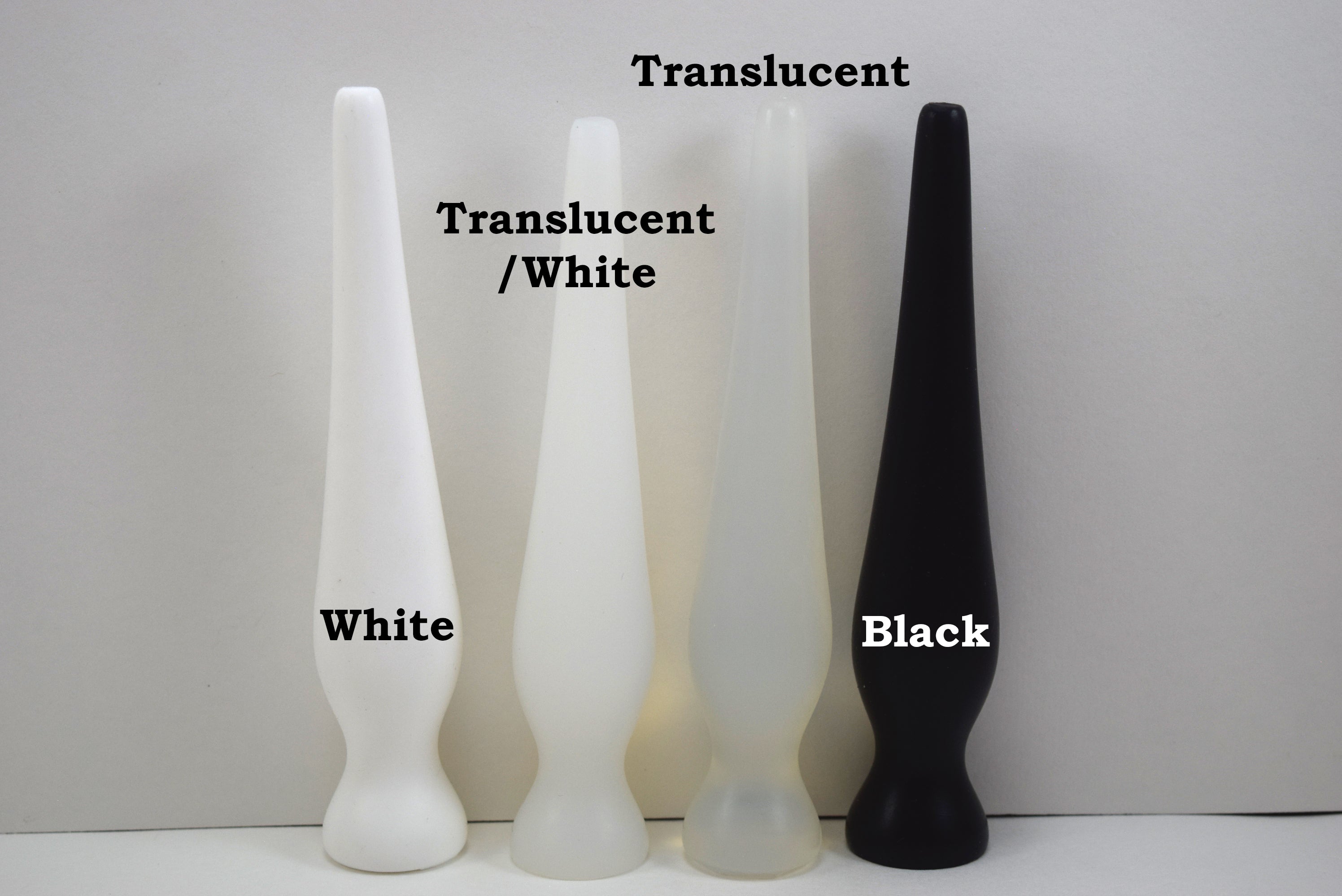 EXT CON 1.0 inch silicone retention plug lineup comparing white, translucent white, clear translucent, and solid black options.