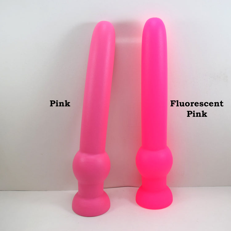 GRB 122 pink silicone colon nozzle showing its 11-inch insertable 1.6-inch diameter shaft, a 2.4-inch grip retention ball, and a flared safety flange on a grid background.