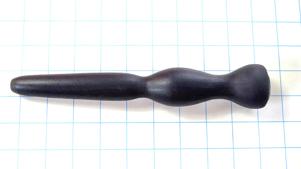 GRB 35 black silicone colon nozzle showcasing its 4.5-inch tapered entry tip, 1.4-inch elliptical expansion ball, dual retention valleys, and 1.5-inch safety flange base on a grid background.