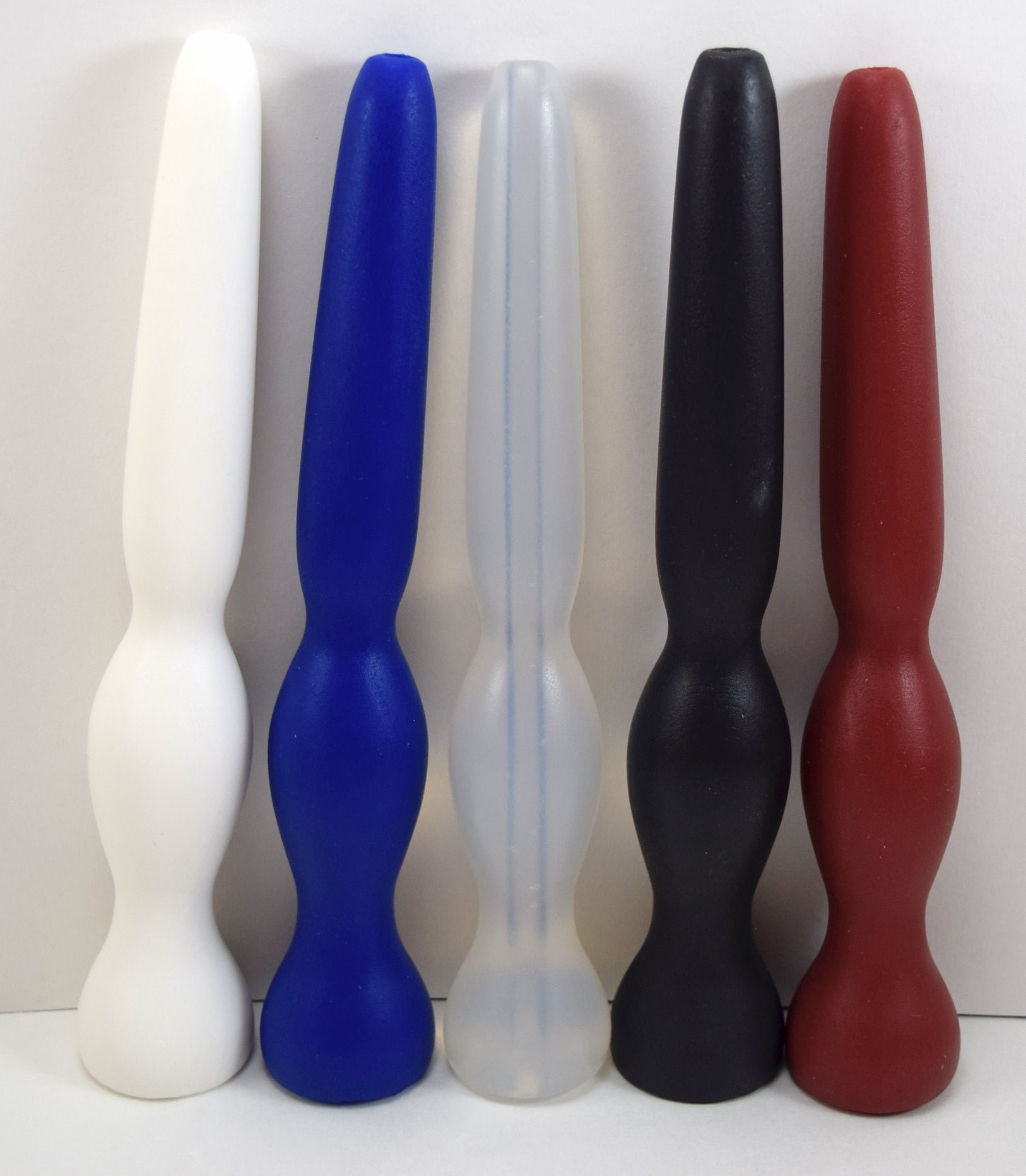GRB35-9 tapered oval ball silicone enema colon nozzle lineup featuring white, blue, translucent, black, and red models with 1.4-inch retention balls, 9-inch total lengths, and 7.5-inch insertable depths.