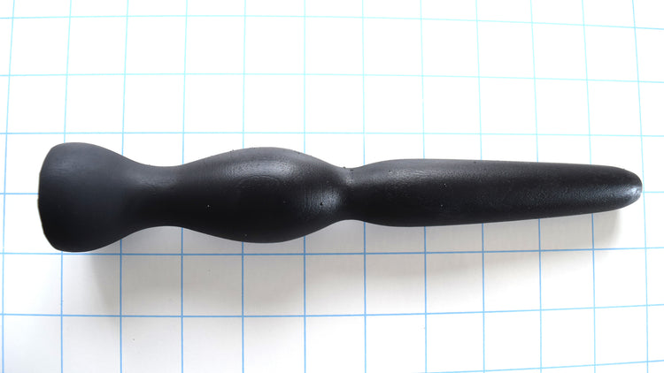 GRB 35 black silicone colon nozzle showcasing its 4.5-inch tapered entry tip, 1.4-inch elliptical expansion ball, dual retention valleys, and 1.5-inch safety flange base on a grid background.