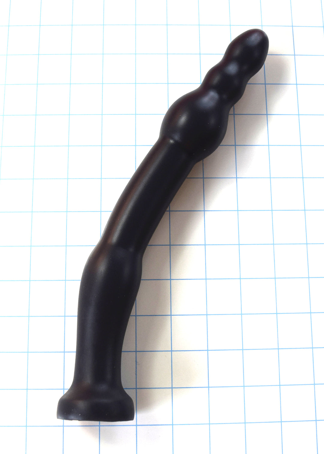 GRB 86 BT black silicone colon nozzle showcasing its curved 1.3-inch shaft, 1.75-inch anchoring ball, and segmented 1.2-inch ball tip on a blue grid background