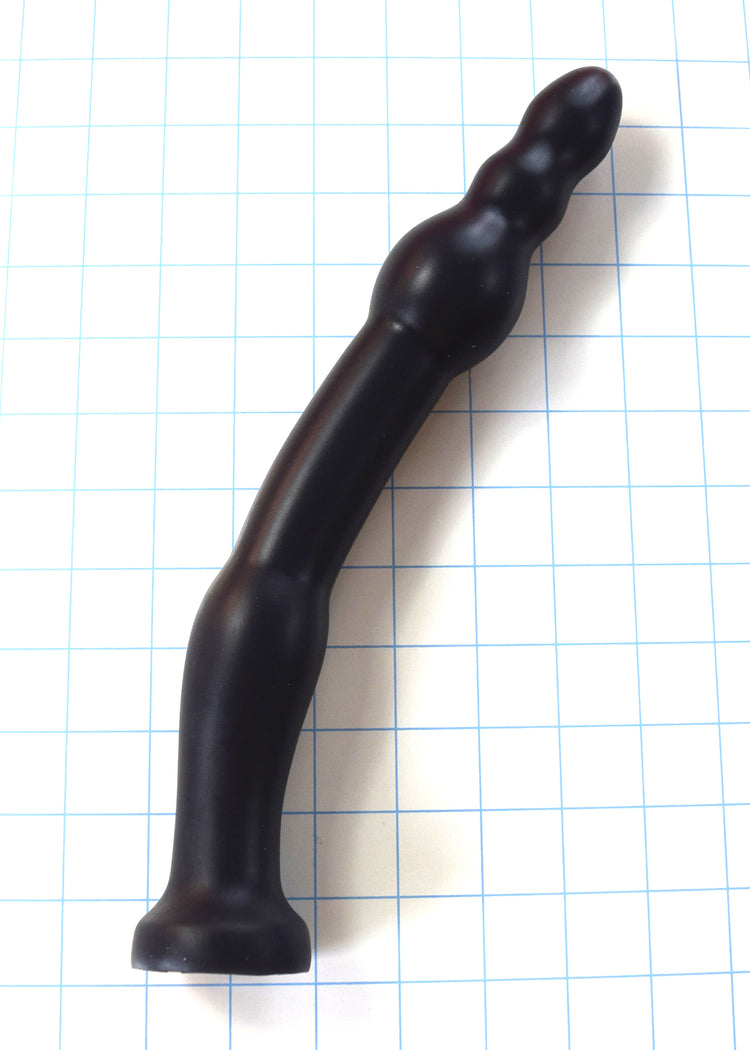 GRB 86 BT black silicone colon nozzle showcasing its curved 1.3-inch shaft, 1.75-inch anchoring ball, and segmented 1.2-inch ball tip on a blue grid background