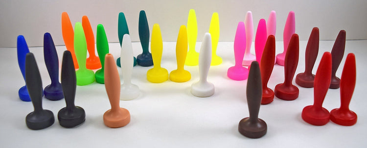 An array of handcrafted silicone nozzles and plugs displaying lighter and darker natural variations of each custom color.