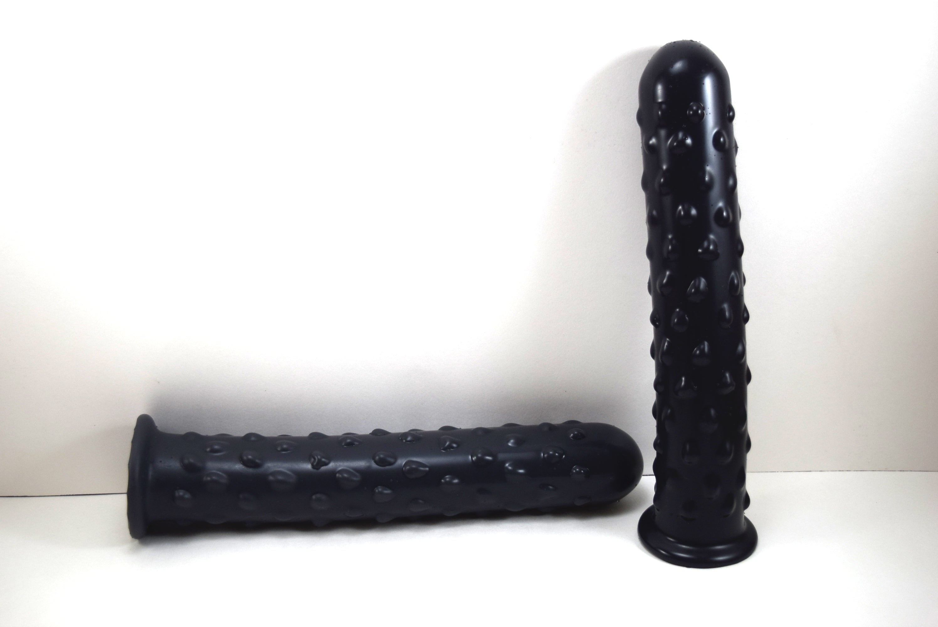 2 Black silicone Knobby Jumbo nozzle with textured surface, 1.75 inch diameter, and safety flange on a white background
