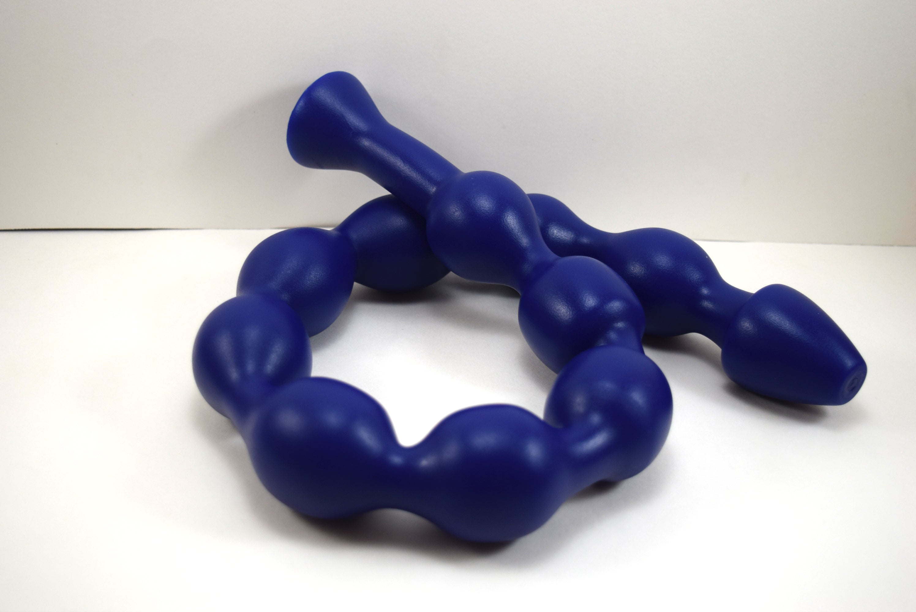 MAXIBALL 30-inch silicone retention ball enema colon nozzle featuring 10 graduated 1.8-inch diameter bulbs, 29-inch insertable length, tapered introductory tip, and a 1.9-inch safety flange base on a blue grid background.