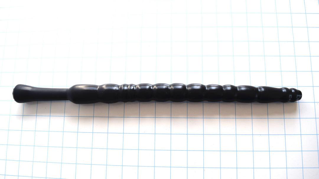 Black MBXL ribbed silicone colon nozzle with a 17.5-inch length and graduated bulb design on a white grid background