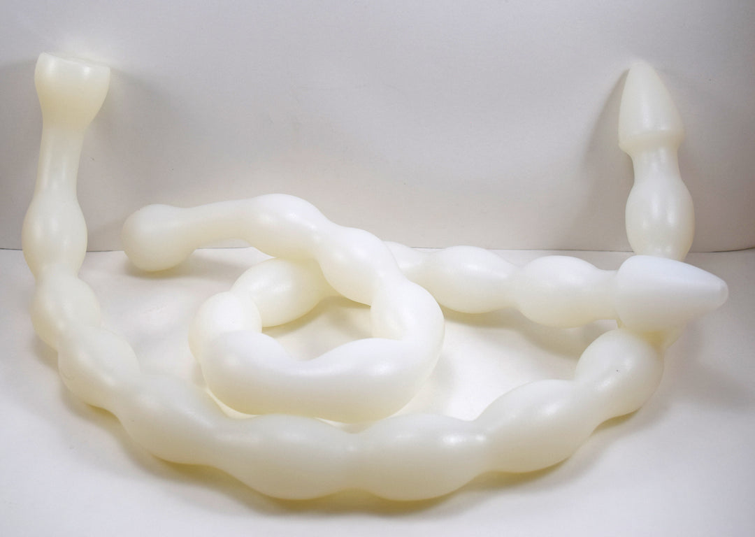 White MINIBALL 31-inch silicone colon tube coiled loosely on a white studio background showing the 10-stage retention bulbs.