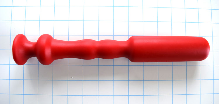 "Model C 12-inch red silicone nozzle featuring a prominent barrel-shaped tip, tapered ribs, and a 2-inch safety flange on a white grid background