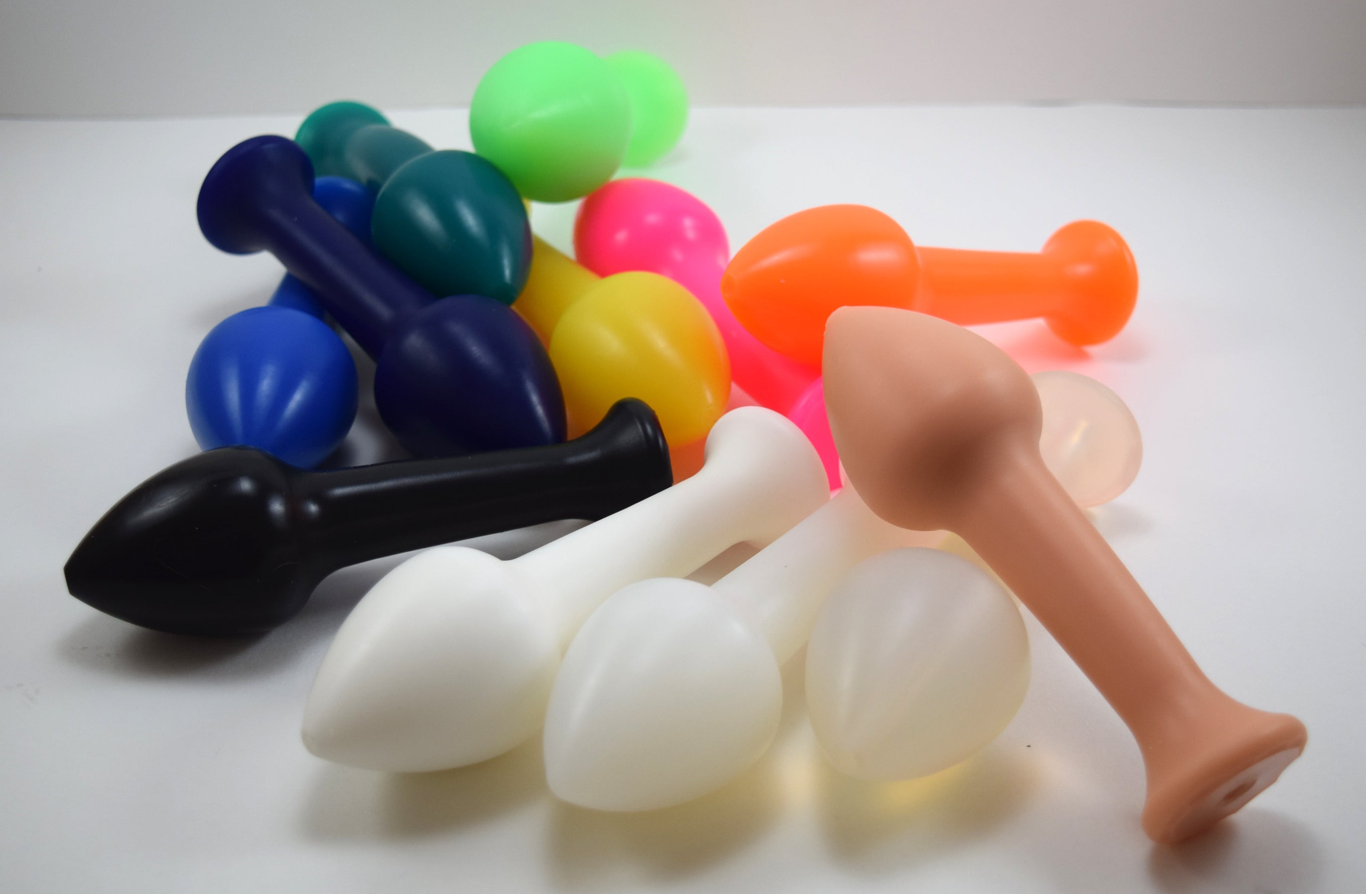 Model Y silicone nozzle in various colors featuring a large, tapered 2-inch tip and 1.5-inch flared base for secure positioning on a white grid background