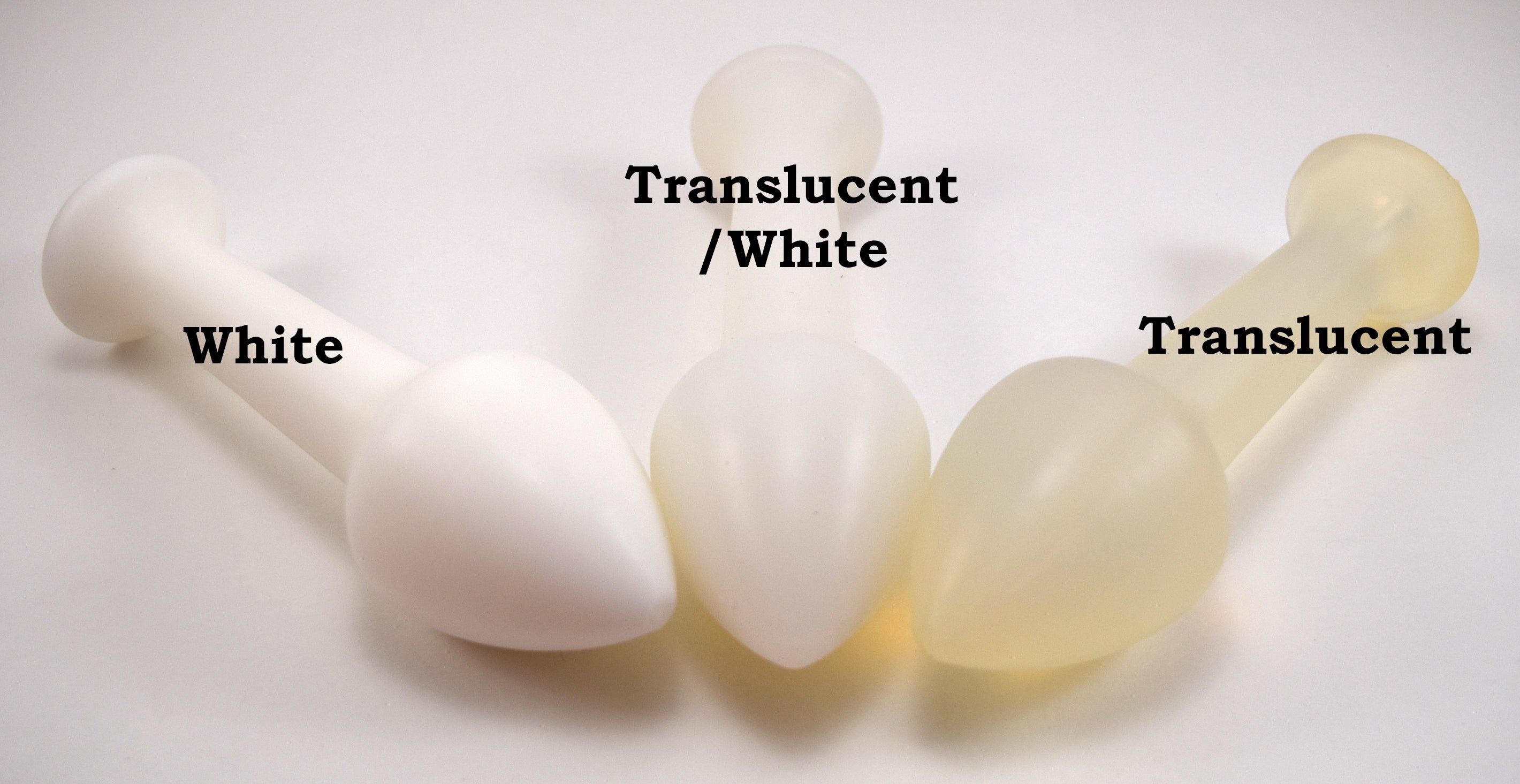 Three Model Y silicone enema nozzles in solid white, translucent white, and pure translucent material options.