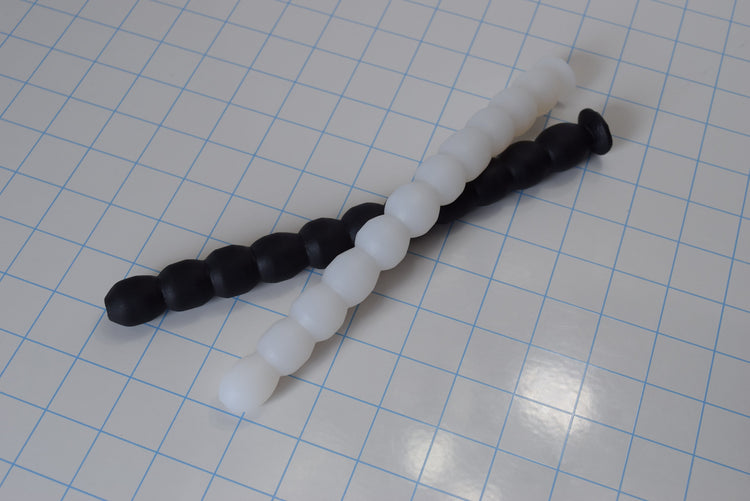 Multi Ball Shaft 9-inch silicone enema nozzle featuring 11 small ribbed balls for gentle, beginner-friendly insertion on a white grid background