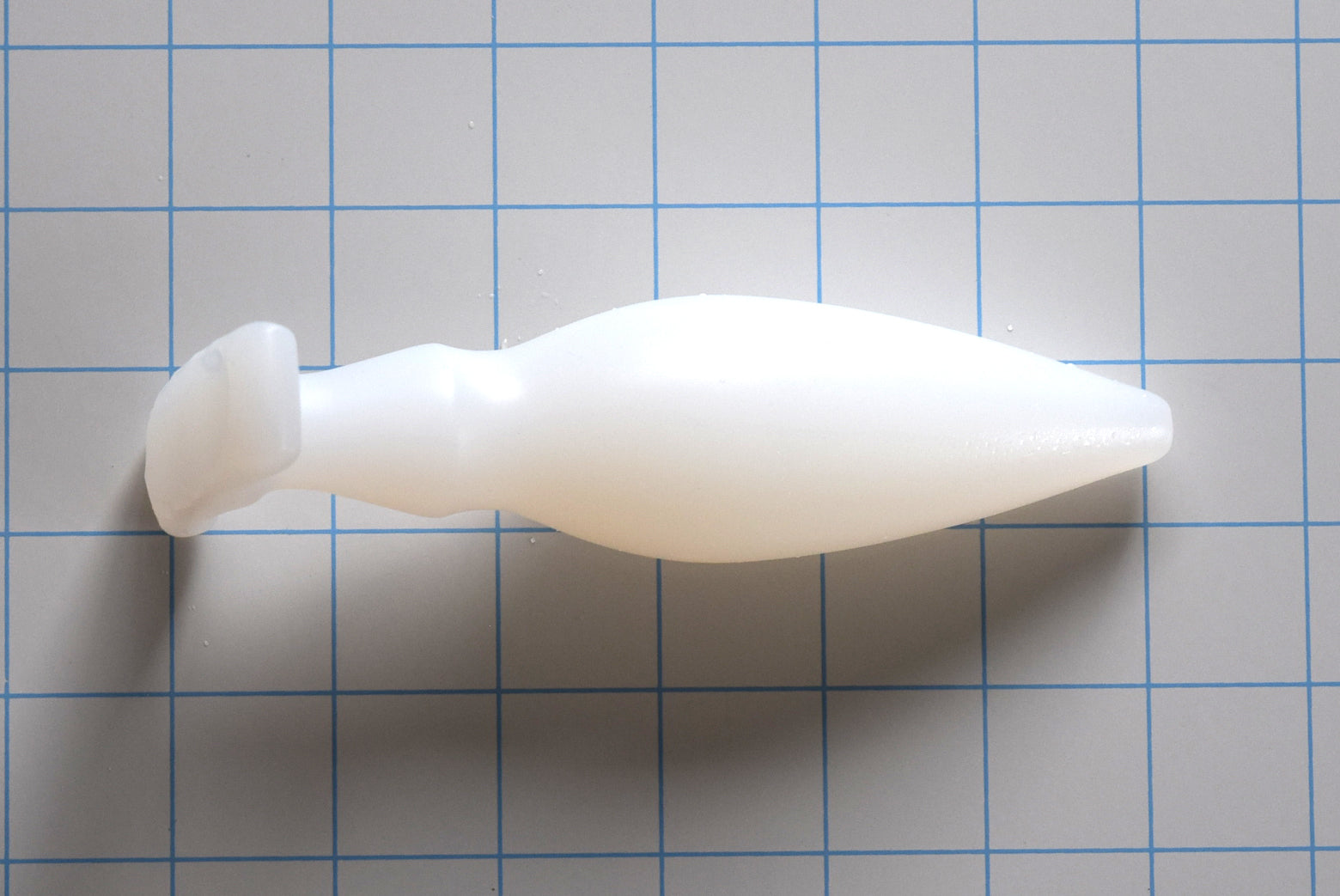 OF 1.6 silicone enema nozzle featuring a 0.5-inch rounded tip, gradual 1.6-inch taper, dual-stage retention valleys, and a 3-inch wide contoured oval gluteal base flange.