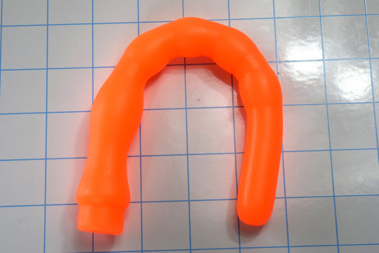8 inch orange ribbed throat trainer bent in U-shape demonstrating soft flexible silicone firmness.