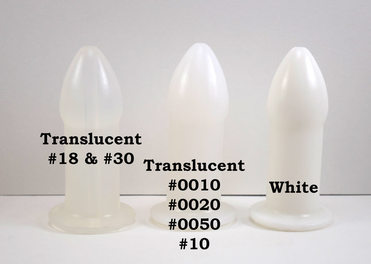 Translucent and opaque white silicone rectal training dilators standing side-by-side on a white surface with text overlay.