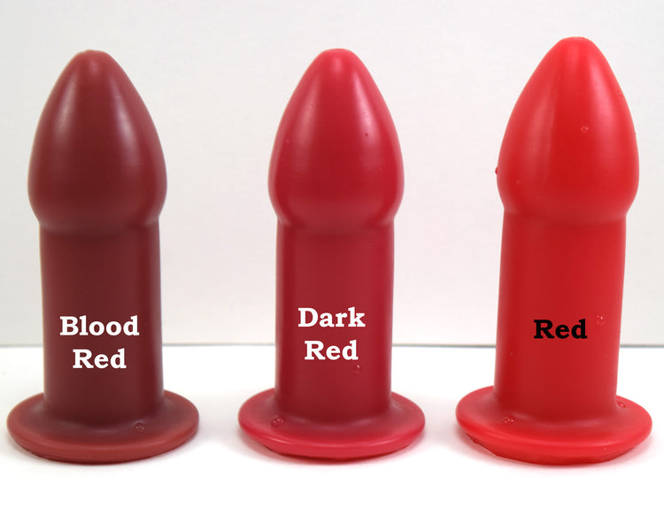 Blood red, dark red, and bright red silicone rectal training dilators standing side-by-side on a white surface with text.