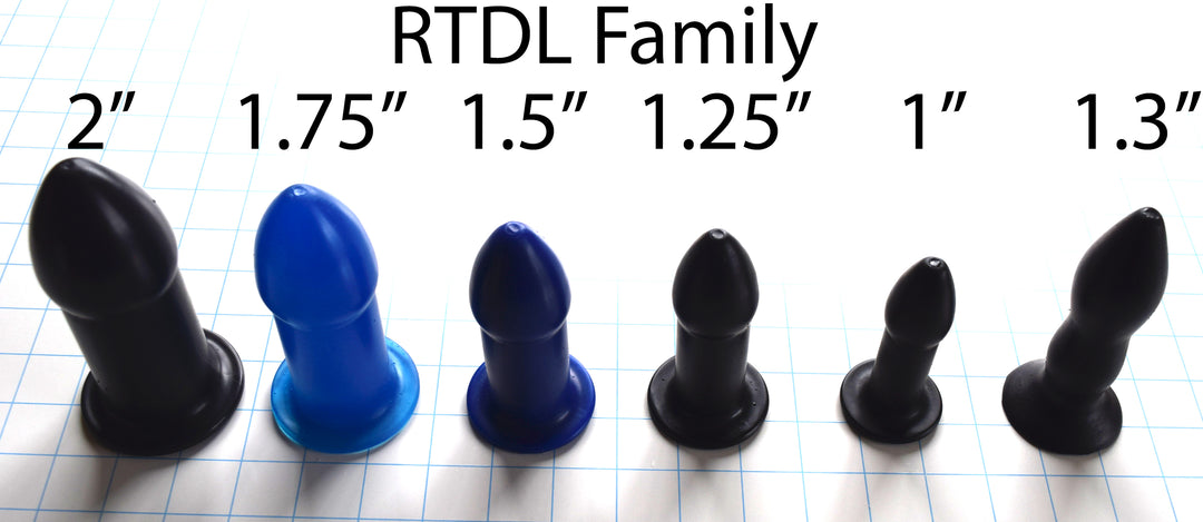 A row of six RTDL silicone retention enema nozzles from 2 inches down to 1.3 inches standing angled on a blue grid base.