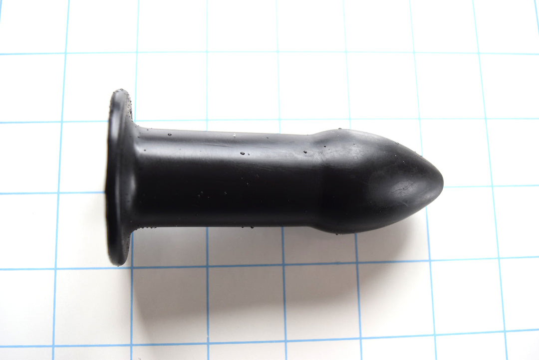 RTDL 1.25 inch rectal training dilator in medical-grade platinum silicone with tapered tip, retention flange, and open bore design