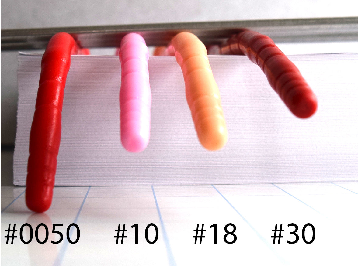 Close-up side-angle view comparison of silicone firmness levels #0050, #10, #18, and #30 drooping over an edge to show material flexibility