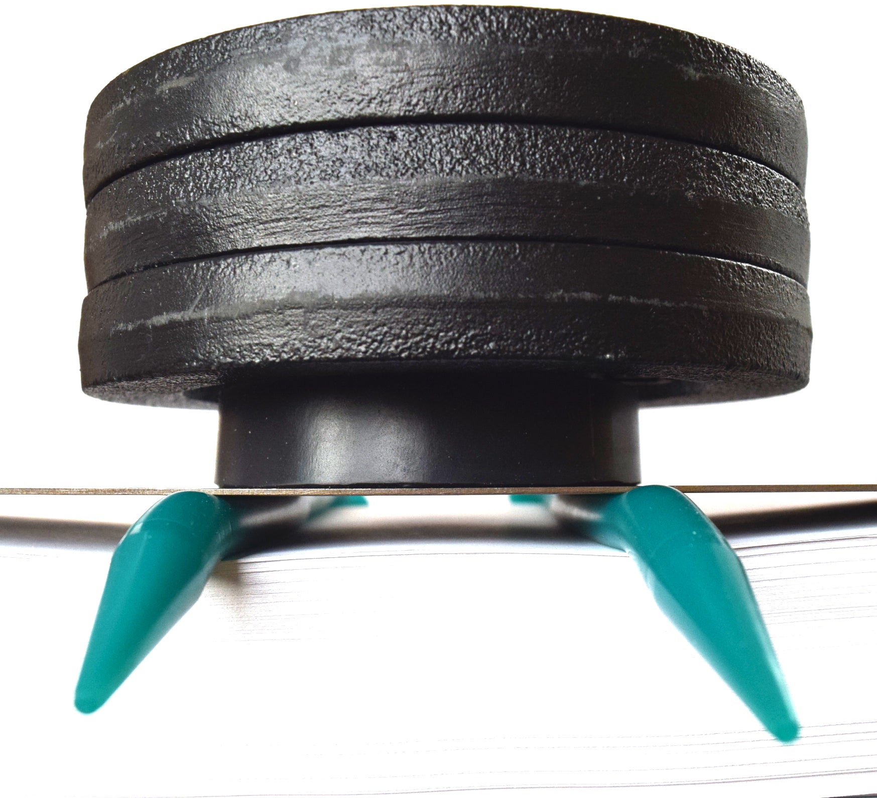15 lb weight compression test on a teal 00-20 firmness silicone tube under a flat steel plate.